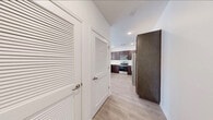 This single-floor residence on Steele Creek Road in Charlotte, NC offers a clean, modern aesthetic throughout. The entryway welcomes you with light wood-style flooring and louvered closet doors, leading directly into the heart of the home. The kitchen is a standout feature, showcasing rich dark espresso cabinetry, white countertops, and a full suite of stainless steel appliances including a range, microwave, and side-by-side refrigerator with ice and water dispenser. Recessed lighting and light hardwood-style flooring complete the polished look. The living areas are bright and airy, with natural light streaming through large windows fitted with blinds. Bedrooms feature plush carpeting, ceiling fans, and generous windows that invite in natural light. The primary bedroom is complemented by an en-suite bathroom with a dual-sink vanity, dark wood cabinetry, white countertops, and a large mirror with modern lighting fixtures. Walk-in closets with wire shelving systems provide ample storage in the bedrooms. Throughout the residence, a cohesive palette of white walls, light flooring, and dark wood accents creates a contemporary and inviting atmosphere.