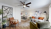 This efficiently designed single-story residence features a thoughtful floor plan that maximizes every square foot across six distinct spaces. The open living and dining area serves as the heart of the home, showcasing warm hardwood-style flooring, a textured ceiling, and a ceiling fan that adds both style and functionality. The living area provides ample room for seating arrangements and flows seamlessly into a dedicated dining space, making it ideal for everyday living and entertaining. Natural light filters in through windows, enhancing the bright, neutral color palette throughout.

The galley-style kitchen is well-equipped with stainless steel appliances, including a refrigerator, range, and dishwasher, complemented by white upper cabinetry, two-tone gray lower cabinets, a subway tile backsplash, and light quartz countertops. The bedroom offers a comfortable and serene retreat, featuring plush carpet flooring, a ceiling fan, a window with drapes, and sufficient space for a full bedroom suite. The bathroom is clean and functional, complete with gray cabinetry, a quartz vanity top, a tiled shower-tub combination, and hardwood-style flooring. A dedicated closet and hallway round out this cohesive and practical living space.
