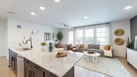 Located in Richmond, TX, this 2-bedroom, 1-bathroom home offers a thoughtfully designed single-floor layout that maximizes comfort and functionality. A bright, art-lined entryway corridor with wood-look flooring leads into the heart of the home. The open-concept kitchen and living area serves as the centerpiece, featuring a spacious granite-topped island with seating, dark cabinetry contrasted by crisp white upper cabinets, stainless steel appliances, and recessed lighting. The kitchen flows seamlessly into the living and dining area, which is bathed in natural light from large windows and a glass door. A ceiling fan, accent wall, and ample room for both lounging and dining make this space highly versatile. The primary bedroom is generously sized, highlighted by a teal accent wall, large windows, a ceiling fan, and direct access to the bathroom. The bathroom is elegantly finished with a dual-sink navy vanity, granite countertops, a glass-enclosed walk-in shower with tile surround, and a soaking tub. Two well-sized closets, including a walk-in with full shelving and hanging rods, provide excellent storage. The second bedroom also features a teal accent wall, natural light, and bathroom access, rounding out this cohesive and stylish home.