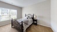 Located at 4214 California Rd in Orchard Park, NY, this well-appointed single-floor residence offers a thoughtfully designed open-concept layout with a clean, modern aesthetic throughout. Light wood-style flooring flows seamlessly across the main living areas, complementing the neutral warm tones of the walls and trim.

The kitchen is a standout feature, outfitted with white shaker-style cabinetry, granite countertops, a subway tile backsplash, and a full suite of stainless steel appliances including a gas range, over-the-range microwave, and French door refrigerator. A kitchen island provides additional prep and seating space.

The living area is open and welcoming, with a sliding glass door that invites natural light and provides access to the outdoors. A dedicated dining area accommodates casual meals with ease.

The bedrooms offer a comfortable retreat, each featuring plush carpeting, neutral walls, and windows that bring in natural light with outdoor views. The bathrooms are finished with granite-topped vanities and wood-style flooring. One bathroom features a walk-in glass-enclosed shower with classic white subway tile surround and grab bars for added accessibility.

The entryway is clean and functional, with multiple interior doors providing organized access to additional storage or utility spaces. This residence combines practical design with quality finishes throughout.