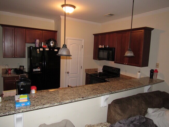 breakfast bar seating opening up to the living room - 139 Red Barn Ln