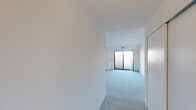 Located at 574 Auten Rd in Hillsborough, NJ, this single-floor, one-bedroom, one-bathroom residence offers a thoughtfully organized layout across a comfortable footprint. The living room is bright and open, featuring carpet flooring, a panel ceiling, and a sliding glass door that leads directly to a private balcony with outdoor views — filling the space with natural light. An adjacent dining area is accented by a classic chain-hung chandelier and a large window dressed with vertical blinds, providing additional illumination. The spacious primary bedroom offers generous proportions, carpeted floors, and access to the hallway, with two closets providing ample storage throughout the unit. The kitchen is efficiently designed with white cabinetry, dark countertops, a mosaic tile backsplash, light tile flooring, white appliances including a refrigerator, electric range, microwave, and dishwasher, and a pendant light overhead. The bathroom features a clean, full tub-shower combination with chrome fixtures. Neutral white walls and light-toned carpeting throughout lend the space a clean, cohesive aesthetic that is move-in ready and easy to personalize.
