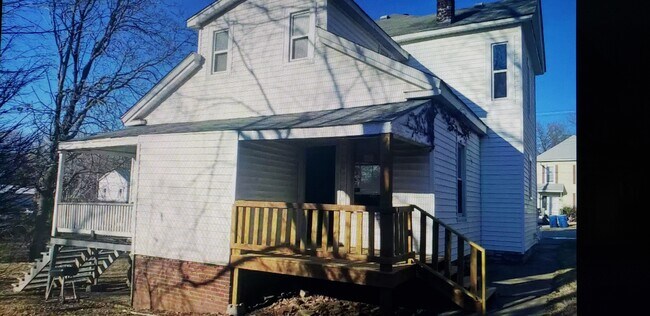 private back deck overlooking yard with trees and shade - 921 E 7th St
