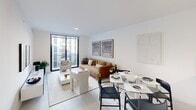 Located along the South River Drive corridor in Miami, this well-appointed one-bedroom, one-bathroom residence offers a thoughtfully designed open-concept layout with clean, modern finishes throughout. The combined kitchen and living area forms the heart of the home, anchored by a sleek white quartz waterfall island with an undermount sink and matte black fixtures. The kitchen is equipped with light wood cabinetry that extends to the ceiling, stainless steel appliances including a French door refrigerator, built-in microwave, and electric range, all illuminated by adjustable track lighting. The living and dining area benefits from an abundance of natural light streaming through full-height sliding glass doors that open to a private balcony, offering views of the surrounding urban landscape. Light-toned tile flooring runs throughout, lending a cohesive and airy feel. The bedroom is a tranquil retreat with a large floor-to-ceiling window framing outdoor views and providing generous natural light. The bathroom features a dual-sink vanity with white countertops, matte black hardware, a large frameless mirror, and a glass-enclosed walk-in shower with full tile surround. Additional conveniences include an in-unit stacked washer and dryer and a dedicated closet for storage.