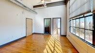 This 560 square foot loft apartment in downtown Winston-Salem combines modern amenities with industrial charm. The open floor plan showcases original hardwood floors and high ceilings with exposed ductwork. Large windows flood the space with natural light and offer city views. The kitchen boasts stainless steel appliances, granite countertops, and rich wood cabinetry. Two closets provide ample storage, while the bathroom features a contemporary tub-shower combo. Industrial-style trim and fixtures throughout maintain the loft's urban aesthetic, creating a stylish and functional living space in the heart of the city.