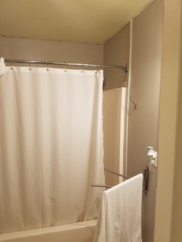 Restroom has curved shower curtain rod - 160 Glendale St