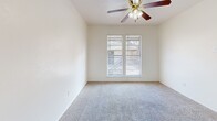 Located in Dallas, TX, this efficient one-bedroom, one-bathroom unit is thoughtfully laid out across a single floor. The open living and dining area features light wood-look vinyl flooring and crisp white walls, creating a bright and clean atmosphere. A peninsula-style pass-through counter connects the living space to the kitchen, offering a functional divider while maintaining an open feel. The kitchen is equipped with warm-toned wood cabinetry, white appliances including a full-size refrigerator and dishwasher, a single-basin sink, and a pantry for additional storage. The bedroom is carpeted for comfort and includes a ceiling fan with light fixture, a window with blinds allowing natural light, and direct access to the bathroom. A closet provides dedicated storage within the unit. The bathroom features wood-toned cabinetry, a long white countertop vanity with an integrated sink, a large mirror, wall-mounted storage cabinets, tiled walls near the tub, and wood-look vinyl flooring. Central HVAC with ceiling vents is present throughout. This unit offers a practical and well-organized layout suitable for single occupancy in a residential community in southwest Dallas.