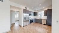 This well-designed 2-bedroom, 2-bathroom residence in Fontana, California offers a thoughtfully planned single-floor layout with a clean, contemporary aesthetic throughout. Light wood-tone flooring flows seamlessly across the living areas, hallways, and bedrooms, lending warmth and visual continuity to the space.

The kitchen is a standout feature, showcasing slate-gray cabinetry with sleek hardware, white quartz countertops, a subway tile backsplash, and a full suite of stainless steel appliances including a French door refrigerator, electric range, over-the-range microwave, and dishwasher. Natural light enters through a window above the sink, brightening the workspace. The kitchen opens directly to the living area, supporting an open-concept flow.

The bedrooms are bright and well-proportioned, each benefiting from natural light through large windows with blinds. The primary bedroom includes a walk-in closet with wire shelving, providing ample storage. Five closets in total are distributed throughout the home. The bathrooms feature clean white tile surrounds with soaking tub and shower combinations and chrome fixtures.

Additional highlights include a dedicated laundry area, a private balcony, recessed lighting throughout, and well-connected hallways offering easy navigation across the floor plan.