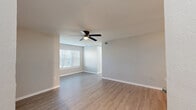 Located at 301 N Gross Rd in Kingsland, Georgia, this single-story, 3-bedroom, 2-bathroom home offers a well-organized layout designed for practical, comfortable living. The open-concept living, dining, and kitchen area serves as the heart of the home, featuring light wood-look vinyl flooring, neutral gray walls, and a ceiling fan with lighting. A peninsula with granite countertops separates the kitchen from the dining and living space, which is accented by a stylish globe pendant light and track lighting overhead. The kitchen is outfitted with white shaker cabinets, granite countertops, and stainless steel appliances including a refrigerator, range, and microwave. The three bedrooms are carpeted and each include ceiling fans and windows with blinds that allow natural light to filter in. The primary bedroom features a spacious walk-in closet with wire shelving. Additional bedrooms include standard closets. Both bathrooms are clean and functional, with one featuring a tub-shower combo with white tile surround and wood-tone hardware accents. The home also includes a dedicated laundry area, a utility room, and ample hallway storage with four closets throughout, ensuring generous organizational space across the entire floor plan.