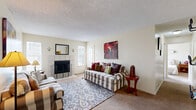 Located at 4380 Burton Way in Colorado Springs, CO, this 2-bedroom, 2-bathroom single-floor home offers a well-organized layout with a comfortable, functional design throughout. The living room serves as the heart of the home, featuring a tile-surround fireplace flanked by two windows that fill the space with natural light, textured ceilings, and plush carpeting. Adjacent to the living area, the dining room provides an intimate space with a window and baseboard heating. The galley-style kitchen is efficiently designed with warm wood cabinetry, granite-toned countertops, hardwood-style flooring, and black appliances including a full-size refrigerator and dishwasher, with direct access to the laundry area. Both bedrooms are carpeted and well-lit; the primary bedroom includes a ceiling fan, while the second bedroom offers a window with outdoor views of the surrounding community. The two bathrooms feature wood cabinetry, stone-toned countertops, and hardwood-style flooring, with one bath including open shelving for additional storage. Four closets provide generous storage throughout. A private patio completes this thoughtfully designed home.