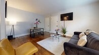 Located in the Mount Airy neighborhood of Philadelphia, this one-bedroom, one-bathroom unit offers a thoughtfully laid-out living space across a single floor. Rich hardwood flooring flows throughout the main living areas and bedroom, providing warmth and visual continuity.

The living room is an inviting, open space with neutral gray walls and natural light from a street-facing window. It comfortably accommodates a seating area and a dining setup side by side, making it versatile for both relaxing and entertaining.

The kitchen is a standout feature, offering ample cabinetry in a warm wood tone, a full suite of appliances including a gas range and microwave, a tiled backsplash, and light stone-look tile flooring. A window allows natural light to brighten the workspace.

The generously sized bedroom is one of the unit's highlights, featuring gleaming hardwood floors, a ceiling fan, a natural light-admitting window, and a closet. Multiple doorways connect to the hallway and adjacent spaces, giving the room a functional, open feel.

The bathroom showcases clean white shiplap-style wainscoting paired with soft gray upper walls, creating a fresh and timeless aesthetic. A hallway connects all rooms, completing the efficient and comfortable floor plan of this Mount Airy residence.
