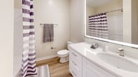 Located at 913 Chardonnay Cir in Brandon, Mississippi, this single-story, 3-bedroom, 2-bathroom home presents a bright and well-maintained interior with a cohesive, modern aesthetic throughout. Light-toned luxury vinyl plank flooring runs through the main living areas and hallways, creating a clean, open feel that connects each room seamlessly.

The kitchen is a standout feature, outfitted with crisp white shaker-style cabinetry, a classic white tile backsplash, light stone countertops, and a full suite of stainless steel appliances including a refrigerator, range, microwave, and dishwasher. Natural light from a skylight enhances the kitchen's bright and functional design.

The living area is spacious and open, with neutral walls and light flooring that maximize the sense of space. Two hallways connect the bedrooms and bathrooms, providing a logical and efficient layout. The bedrooms feature plush carpeting and windows with blinds that allow natural light to filter in; ceiling fans are present in select rooms. Multiple closets are found in the primary bedroom area, offering ample storage.

Both bathrooms are finished with white vanities, light countertops, wood-style flooring, and tub-shower combinations. A dedicated laundry room adds everyday convenience. The overall palette of whites and warm neutrals gives the home a clean, move-in-ready character.