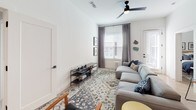 Located at 4600 Ross Ave in Dallas, Texas, this thoughtfully designed single-story residence offers a contemporary aesthetic with clean lines and modern finishes throughout. The open-concept living area is bright and welcoming, featuring light wood-style flooring, a ceiling fan, and multiple windows that invite natural light while offering views of the surrounding urban neighborhood. A dedicated dining nook with soaring wall height provides an elegant space for entertaining.

The kitchen is a standout feature, showcasing a two-tone cabinet design with white upper cabinets and slate-gray lower cabinets, stainless steel appliances, a hexagonal tile backsplash, and quartz countertops that extend to a generous island or peninsula for additional prep and seating space.

The primary bedroom is spacious and serene, with high ceilings, large windows, and light flooring that create a calm retreat. Its en-suite bathroom features a sleek walk-in shower with black-framed glass doors and a dual-sink vanity. The second bedroom is equally comfortable, offering ample natural light and window treatments. The secondary bathroom includes a soaking tub and shower combination with clean tile surrounds and a modern vanity. Every room reflects a cohesive, contemporary design sensibility throughout.