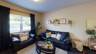 Located at 5088–5098 Station Rd in Erie, PA, this single-floor unit is designed for shared living, offering a functional and well-organized layout across multiple private bedrooms and shared common areas. The kitchen is equipped with light oak cabinetry, a full-size refrigerator, electric range, built-in microwave, and a stainless steel sink, all set atop tile flooring that adds a clean, practical touch. Adjacent to the kitchen, a dedicated dining area provides space for shared meals. The living room offers a comfortable, open feel with carpet flooring, warm neutral-toned walls, and windows that bring in natural light and outdoor views. Each private bedroom features carpeted floors, a single bed, a study desk with chair, and a closet, making them well-suited for focused, independent living. Select bedrooms include windows with blinds and curtains for added privacy and light control. The unit includes multiple bathrooms, each featuring a shower-tub combination, toilet, and vanity with mirror. Throughout the unit, the design maintains a consistent, understated aesthetic with neutral wall tones and practical finishes suited to everyday residential use.