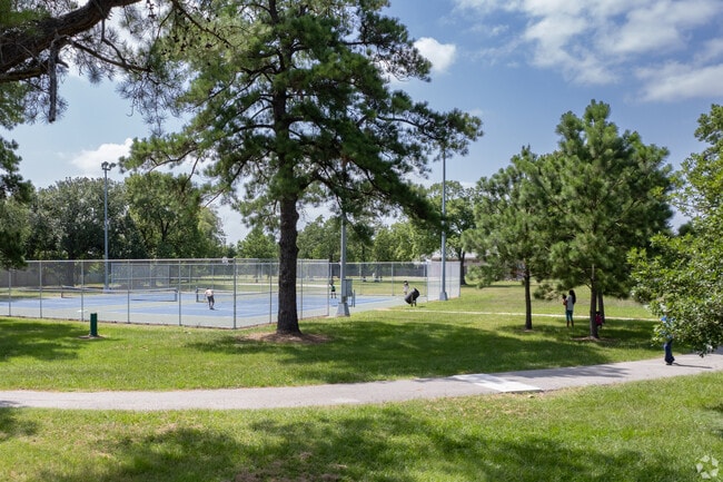 Residents play tennis at a park in Spring Branch.