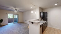 Located at 1195 Selmi Dr in Reno, Nevada, this single-floor, 3-bedroom, 2-bathroom home offers a well-designed layout with a comfortable blend of functionality and style. The open-concept kitchen and living area serves as the heart of the home, where a peninsula with a granite-style countertop and pendant lighting connects the kitchen to the carpeted living space. The kitchen is equipped with dark espresso cabinetry, light wood-look flooring, a gas range, built-in microwave, refrigerator, and a tile backsplash that adds a decorative touch. The living room features a ceiling fan and sliding glass door leading to a private outdoor patio, filling the space with natural light. The primary bedroom includes a ceiling fan, crown molding, sliding glass door access to the patio, and a spacious walk-in closet with wire shelving. The additional bedrooms are carpeted with ample closet space. Both bathrooms mirror the home's consistent aesthetic, featuring dark wood vanities with granite-style countertops, tile-style flooring, and a tub-shower combination. A hallway connects the bedrooms and bathrooms, and additional closet storage is available throughout.
