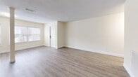 Located at 26 Beacon St in Burlington, MA, this one-bedroom, one-bathroom residence offers a well-organized single-floor layout designed for comfortable everyday living. The open living area is a standout feature, showcasing durable hardwood-style flooring, warm cream-toned walls, and a distinctive structural column that adds architectural character to the space. A bank of windows along the front wall floods the room with natural light and provides views of the surrounding neighborhood. The living area flows seamlessly toward the kitchen, which is well-appointed with crisp white cabinetry, granite countertops, a stainless steel refrigerator, dishwasher, and range, all set atop light wood-style flooring. The bedroom is a comfortable, carpeted retreat featuring a window that brings in natural light and includes a closet for storage. A textured ceiling adds subtle detail throughout the unit. The bathroom is clean and functional, finished with tile flooring and a full soaking tub with shower. Throughout the unit, neutral tones, clean white trim, and consistent finishes create a cohesive and move-in-ready atmosphere suited for a variety of lifestyles.