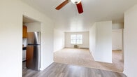 Located at 100 Stratford Ln in Middletown, NY, this single-floor residence offers a practical and comfortable layout with two bedrooms, two bathrooms, a living room, and a kitchen. The living area features a combination of plush carpeting and hardwood-style flooring, with a ceiling fan overhead and a sliding glass door that invites natural light and outdoor views. Baseboard heating is present throughout the home, ensuring year-round comfort.

The kitchen is equipped with warm wood cabinetry, granite-style countertops, a stainless steel range, and wood-style flooring underfoot. A window above the counter fills the space with natural light. The spacious primary bedroom offers generous closet space with double sliding doors and windows that provide pleasant outdoor views. The second bedroom is similarly well-lit, with multiple windows and baseboard heating.

Both bathrooms are cleanly finished; one features a white vanity with an oval mirror, while the other includes a full tub-shower combination with stone-look tile surround. Neutral tones and clean white walls create a bright, move-in-ready atmosphere throughout the home.