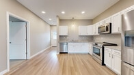 Located at 4340 Belden Greens Cir NW in Canton, Ohio, this well-appointed 2-bedroom, 2-bathroom single-story home offers a thoughtfully designed layout with modern finishes throughout. Light-toned luxury vinyl plank flooring runs through the main living areas, complemented by neutral warm-beige walls and recessed lighting that creates a bright, welcoming atmosphere.

The open-concept kitchen and living room form the heart of the home, with the kitchen showcasing white shaker-style cabinetry, granite countertops, and a full suite of stainless steel appliances including a French door refrigerator, range, microwave, and dishwasher. A pendant light adds a finishing touch above the workspace. The living area flows effortlessly from the kitchen and opens to the outdoors through a sliding glass door fitted with vertical blinds, allowing an abundance of natural light.

A hallway connects the main living space to two well-sized bedrooms, each featuring plush carpet, natural window light, ceiling fans, and generous closet space. The primary bedroom includes a walk-in closet with wire shelving. Both bathrooms are finished with white cabinetry, granite-topped vanities, and wood-look flooring. Two hallways and additional closets provide practical storage throughout this comfortable and move-in-ready home.