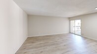 Located at 1194 Casa Brazilia Dr in Saint Louis, Missouri, this 2-bedroom, 2-bathroom single-floor residence offers a clean, modern aesthetic throughout. Light-toned hardwood-style flooring runs continuously across the living spaces, lending a bright and cohesive feel to the interior.

The open living room is a generous, airy space featuring neutral warm-beige walls, a textured ceiling, and sliding glass door access to a private balcony, allowing natural light to pour in. The kitchen is thoughtfully appointed with white shaker-style cabinetry, a white subway tile backsplash, sleek marble-patterned quartz countertops, a gas cooktop, stainless steel refrigerator, and a stainless steel sink — combining both style and function.

Both bedrooms are comfortably sized with the same light flooring and neutral walls. The primary bedroom offers ample space, while the second bedroom features a large window with views of the surrounding neighborhood. Both bathrooms are outfitted with full tub-shower combinations clad in crisp white subway tile and chrome fixtures, giving them a clean, contemporary look.

The unit also includes a dedicated entryway with a front door. The overall design emphasizes a light, neutral palette that creates a welcoming and move-in-ready environment.