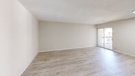Located at 1194 Casa Brazilia Dr in Saint Louis, Missouri, this 2-bedroom, 2-bathroom single-floor residence offers a clean, modern aesthetic throughout. Light-toned hardwood-style flooring runs continuously across the living spaces, lending a bright and cohesive feel to the interior.

The open living room is a generous, airy space featuring neutral warm-beige walls, a textured ceiling, and sliding glass door access to a private balcony, allowing natural light to pour in. The kitchen is thoughtfully appointed with white shaker-style cabinetry, a white subway tile backsplash, sleek marble-patterned quartz countertops, a gas cooktop, stainless steel refrigerator, and a stainless steel sink — combining both style and function.

Both bedrooms are comfortably sized with the same light flooring and neutral walls. The primary bedroom offers ample space, while the second bedroom features a large window with views of the surrounding neighborhood. Both bathrooms are outfitted with full tub-shower combinations clad in crisp white subway tile and chrome fixtures, giving them a clean, contemporary look.

The unit also includes a dedicated entryway with a front door. The overall design emphasizes a light, neutral palette that creates a welcoming and move-in-ready environment.