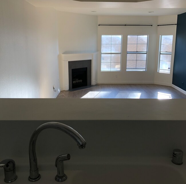 A straight view from the kitchen to the living room with a counter and buffet storage. - 716 Maltman Ave