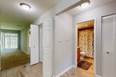 Located in Northville, MI, this single-floor, 2-bedroom, 2-bathroom home offers a functional and comfortable layout. The open-concept kitchen connects seamlessly to the living area, featuring warm wood cabinetry, granite countertops, stainless steel appliances, and a peninsula breakfast bar — ideal for both cooking and casual dining. The living room is carpeted and filled with natural light from large sliding glass doors fitted with vertical blinds, offering pleasant outdoor views of the surrounding greenery.

Both bedrooms are carpeted and generously sized, with the primary bedroom providing ample space for a full furniture arrangement. Each bedroom benefits from access to sliding glass doors and outdoor views, enhancing the sense of openness throughout. Two dedicated closets provide practical storage solutions.

The two bathrooms are well-appointed; one features a walk-in glass-door shower, wood-toned vanity, granite countertop, and tile flooring, while the second includes a shower/tub combo with a decorative curtain, wood vanity, and matching granite countertop. A connecting hallway with light wood-style flooring ties the layout together efficiently, providing easy access to all rooms. This home offers a clean, cohesive design throughout.