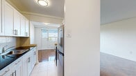 Located at 1833 Bayview Avenue in Toronto's sought-after Leaside neighbourhood, this one-bedroom, one-bathroom unit offers a well-proportioned and functional living space across a single floor. Throughout the unit, rich parquet hardwood flooring adds warmth and character, complementing the clean white walls and bright, airy atmosphere.

The living room is generously sized, featuring a large multi-pane window that fills the space with natural light and offers views of the surrounding neighbourhood, including greenery and adjacent rooftops. A classic radiator beneath the window provides efficient, radiant heating. The open, neutral palette makes the space highly versatile for a variety of furnishing styles.

The bedroom is a comfortable size, equipped with a window overlooking the cityscape and a built-in mirrored sliding closet that adds both storage and a sense of depth to the room. The same gleaming parquet flooring continues here, maintaining a cohesive aesthetic throughout.

The bathroom is finished in neutral beige tile, featuring a full-sized soaker tub with an overhead handheld shower, a pedestal sink, and a mirrored medicine cabinet — all in a clean, well-maintained condition.

Overall, this unit presents a bright, practical, and classic living environment well-suited to those seeking a comfortable home in one of Toronto's established residential neighbourhoods.