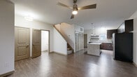 Located at 6159 Winthrop Ave in Indianapolis, Indiana, this two-story, 3-bedroom, 3-bathroom home offers a well-designed layout spread across two floors. The main level features an open-concept living area with rich hardwood-style flooring, a ceiling fan, and large windows that invite natural light. The kitchen is a standout, appointed with dark espresso cabinetry, granite countertops, a central island, stainless steel appliances, and pendant lighting, creating a sleek and functional space. A staircase connects the main level to the upper floor, where the bedrooms are carpeted for comfort. The primary bedroom includes a ceiling fan and ample closet space. Additional bedrooms feature ceiling fans and natural light from exterior windows. The bathrooms are finished with granite-topped dark vanities and tub-shower combinations. A dedicated laundry room on the upper level includes a full-size washer and dryer along with wire shelving for storage. Two closets provide further organizational space throughout the home. Clean, neutral tones and consistent finishes across both floors give the home a cohesive, modern aesthetic throughout.