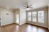 Located on Highway 6 N in Houston, TX, this one-bedroom, one-bathroom unit offers a well-designed single-floor layout that makes efficient use of its space. Wood-look flooring runs throughout, lending a warm and cohesive feel to each room.

The combined kitchen and living area forms the heart of the unit. The kitchen is outfitted with white shaker cabinets, a white subway tile backsplash, granite countertops, a stainless steel sink, and stainless steel appliances including a refrigerator, electric range, microwave, and dishwasher. A peninsula counter separates the kitchen from the living area, which features crown molding, a ceiling fan, and multiple windows fitted with white blinds that allow ample natural light and outdoor views.

The bedroom is a comfortable, well-lit retreat with a ceiling fan, wood-look flooring, and a window with blinds. A utility room provides additional functional space within the unit.

The bathroom is cleanly appointed with a combination shower and bathtub, a floral shower curtain, a toilet, and a granite-topped vanity, complemented by wood-look flooring and neutral wall tones. Throughout the unit, the consistent use of neutral colors, clean finishes, and natural light creates a bright and practical living environment.