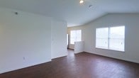 Located at 400 W Crestwood Dr in Camp Hill, Pennsylvania, this single-floor home offers a welcoming and functional layout designed for comfortable everyday living. The interior is characterized by rich, dark hardwood flooring that runs throughout the main living area, providing warmth and visual continuity across the space. Crisp white walls and a clean, neutral palette create a bright and airy atmosphere that feels open and inviting. Multiple windows allow generous natural light to fill the room, enhancing the sense of space and connecting the interior to the surrounding environment. The living area features a gently vaulted ceiling that adds architectural interest and contributes to the open feel of the space. Recessed lighting provides additional illumination, ensuring the space remains well-lit at all hours. A half-wall partition subtly defines separate zones within the open floor plan while maintaining visual flow between areas. The overall design is understated and versatile, offering a neutral canvas well-suited to a variety of interior styles. The combination of natural light, quality flooring, and thoughtful layout makes this home a practical and appealing residence in the Camp Hill area.