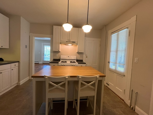 Kitchen with school house pendants and center island with seating for 2 - 46 Fairview St