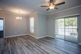 Located at 520 Windview Way in Knoxville, TN, this single-floor home offers a thoughtfully designed layout with clean, contemporary finishes throughout. The open living area features light-toned luxury vinyl plank flooring, crown molding, and a ceiling fan, creating a bright and comfortable atmosphere. A sliding glass door floods the space with natural light and provides direct access to an outdoor area, while a chandelier adds an elegant touch to the adjoining dining space.

The kitchen is well-equipped with white shaker-style cabinetry, granite countertops, stainless steel appliances including a range, over-the-range microwave, and refrigerator, all complemented by light hardwood-style flooring. A peninsula countertop connects the kitchen seamlessly to the living area.

The bedroom features plush carpeting, crown molding, a ceiling fan, and a generously sized window that brings in abundant natural light. The bathroom is finished with a white vanity, granite countertop, large mirror, and wood-style flooring, offering a clean and functional design. Additional conveniences include an in-unit washer with overhead shelving. The overall aesthetic is light, neutral, and move-in ready.