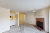 Located at 4054 Braeswood Dr SW in Huntsville, Alabama, this single-floor, 1-bedroom, 1-bathroom residence offers a well-organized layout across a compact and functional footprint. The living area is a standout, featuring a classic brick-surround fireplace with a white mantel, carpet flooring, and a textured ceiling. A pass-through opening connects the living space to the kitchen, enhancing the open feel between rooms. A secondary living area provides additional flexible space, ideal for a dining room or home office. The galley-style kitchen is efficiently designed with warm wood cabinetry, white countertops, a double-basin sink, tile flooring, and full appliances including a range and refrigerator. A dedicated laundry room with washer and dryer hookups and built-in shelving adds everyday convenience. The bedroom is a comfortable size, finished with plush carpet, a window with natural light, and access to a dedicated walk-in closet with built-in shelving. The bathroom features tile flooring, a vanity with storage, and a separate water closet. Textured ceilings are consistent throughout, and the neutral color palette gives the home a clean, move-in-ready appearance.