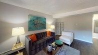 This single-floor residence offers a thoughtfully designed layout that balances comfort and functionality across its main living spaces. The galley-style kitchen is outfitted with dark espresso cabinetry, granite-style countertops, hardwood-style flooring, and a full suite of black appliances, including a refrigerator, electric range, microwave, and dishwasher, making it a practical and stylish space for cooking. Adjacent to the kitchen, the dining area benefits from natural light through a window with blinds and features a ceiling fan with a decorative light fixture, creating a welcoming spot for everyday meals. The living room is a comfortable retreat with hardwood-style flooring, a sliding glass door that opens to an outdoor area, and neutral walls that complement a variety of décor styles. A fireplace serves as a focal point in the main living space, adding warmth and character. Both bedrooms are finished with plush carpeting and feature sliding closet doors with built-in shelving for generous storage. The hallway connecting the sleeping areas showcases additional closet space and leads to the bathroom, which is appointed with a dark-toned vanity and granite-style countertop. Throughout the residence, textured ceilings and neutral tones create a cohesive, understated aesthetic.
