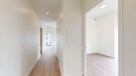 Located at 25 Gibbs Road in Toronto's west end, this well-appointed 3-bedroom, 2-bathroom unit offers a thoughtfully designed single-floor layout with a clean, contemporary aesthetic throughout. Light-toned hardwood flooring flows seamlessly across the living spaces, complemented by crisp white walls and modern trim.

The open-concept living and dining area is a standout feature, anchored by large floor-to-ceiling windows with sleek black frames that flood the space with natural light and provide expansive outdoor views. The kitchen is outfitted with white flat-panel cabinetry, stainless steel appliances including a refrigerator, range, microwave, and dishwasher, and a clean tile backsplash.

Each of the three bedrooms is finished with the same warm hardwood flooring and neutral walls. Select bedrooms feature floor-to-ceiling windows or sliding glass doors offering outdoor views, while others include mirrored sliding closet doors, maximizing both storage and the sense of space.

The two bathrooms are finished in a modern style. One features a soaking tub with large-format tile surround and chrome fixtures, while the second offers a vanity with an integrated sink, illuminated mirror, and tile flooring. A hallway connects the rooms, completing this well-organized and contemporary residential layout.