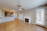 Located at 1113 Baywood Dr in Petaluma, CA, this well-designed one-bedroom, one-bathroom residence offers a thoughtful single-level layout with a comfortable sense of space. The open-concept living, dining, and kitchen area serves as the heart of the home, anchored by warm wood-style hardwood flooring and a classic fireplace with a clean white surround. A ceiling fan with integrated lighting adds both function and style to the living space, which also features a glass-paneled exterior door that invites natural light. The kitchen is appointed with modern wood-grain cabinetry, quartz countertops, stainless steel appliances including a gas range, microwave, and French door refrigerator, and a peninsula island with pendant lighting — ideal for casual dining or meal prep. The bedroom is carpeted for comfort, features a window with outdoor views, and connects conveniently to the full bathroom. Two closets provide ample storage. A dedicated in-unit laundry area with a stacked washer and dryer, along with a separate utility room, add everyday convenience. Neutral tones throughout create a clean, cohesive aesthetic that adapts easily to any style.