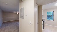 Located at 801 Fairmaiden Ln in Brandon, FL, this single-floor residence offers three bedrooms and two bathrooms across a well-utilized floor plan. The open living and dining area is generously sized, featuring plush wall-to-wall carpeting, a textured ceiling, and a ceiling fan with light fixture. A large sliding glass door fills the space with natural light and provides access to a balcony overlooking lush greenery. The kitchen features light tile flooring, white cabinetry with stone countertops, and a stainless steel refrigerator, with a window offering an exterior view. The bedrooms are carpeted and finished in neutral tones, each offering closet storage — one bedroom features a full wall of built-in bifold closets. The primary bedroom is a comfortable size, providing ample space for furnishings. Both bathrooms are well-appointed; one includes a tub-shower combination with white tile surround, and the other features a wide vanity with a stone countertop, undermount sink, brushed nickel fixtures, and a large mirror. Throughout the residence, a consistent neutral color palette and clean finishes create a calm, functional ambiance suited for everyday living.