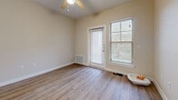 This 640 square foot apartment in Leander, TX offers a thoughtful layout that maximizes efficiency and comfort. The single-floor plan comprises one bedroom, one bathroom, a kitchen, and a living room, all connected by a central hallway. The primary bedroom, measuring 210 square feet, features plush carpeting, a ceiling fan, and a large window that invites natural light.

The kitchen showcases modern appliances, including a black refrigerator and stove, complemented by white cabinetry and light wood-look flooring. A breakfast bar with a granite countertop separates the kitchen from the living area, enhancing the open-concept design. The living room continues the wood-look flooring and offers ample space for relaxation and entertainment.

The bathroom is equipped with a single vanity featuring a granite countertop, matching the kitchen's aesthetic. Throughout the apartment, neutral-toned walls create a bright, airy atmosphere. Ceiling fans in main living areas and the bedroom provide air circulation and comfort. Large windows with blinds offer views of the surrounding area, including glimpses of an outdoor pool. This compact yet well-designed space at 960 Merrill Dr combines functionality with modern comfort, ideal for singles or couples seeking an efficient living solution.