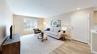 Located at 241 W Buchanan Rd in Pittsburg, California, this single-story residence offers a thoughtfully designed layout that maximizes every square foot. The open-concept living room serves as the heart of the home, featuring light wood-style flooring, warm neutral walls, and a large window with vertical blinds that floods the space with natural light and provides views of the surrounding neighborhood.

The galley-style kitchen is efficiently arranged with light wood cabinetry, white countertops, a double-basin stainless steel sink, and black appliances including a refrigerator, electric range, and over-the-range microwave. A pass-through window connects the kitchen to the living area, enhancing the open feel of the space.

The primary bedroom is a comfortable retreat, finished with plush carpet, warm beige walls, and a window that brings in natural light. Two full bathrooms serve the residence — one featuring a vanity with warm wood cabinetry, a large mirror with overhead lighting, and a separate tub/shower combination. A dedicated closet and in-unit laundry area add to the practicality of this well-rounded home.