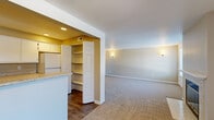 This single-floor, three-bedroom, one-bathroom home offers a thoughtfully arranged layout that maximizes functionality across its living spaces. The carpeted living room serves as the heart of the home, featuring a tile-surround fireplace flanked by a large window that fills the space with natural light. A sliding glass door provides access to an outdoor area, further enhancing the room's openness. Built-in shelving on one wall adds convenient storage and display options.

The kitchen is efficiently designed with wood-look flooring, white cabinetry, light granite-style countertops, and a full suite of white appliances including a range, microwave, dishwasher, and refrigerator. A pantry with bifold doors and shelving sits adjacent to the kitchen, offering ample storage. The kitchen opens toward a secondary living or dining area, creating a connected feel.

Each of the three bedrooms features neutral carpet, bright white walls, and windows with exterior views, including the generously sized primary bedroom. The full bathroom is clean and functional, with a tub-shower combo, vanity with stone-top counters, and wood-look flooring. A dedicated laundry room with a full-size washer and dryer completes this practical and comfortable home.