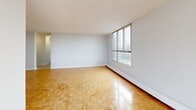 This contemporary apartment, located at 4001 Steeles Ave W in Toronto, offers 93 square meters of well-designed living space. The unit features three bedrooms, including a primary bedroom of 14 square meters, and one bathroom. The open-concept layout combines the kitchen and living room, creating a spacious feel.

Throughout the apartment, beautiful parquet flooring adds warmth and character. Large windows in the living areas and bedrooms flood the space with natural light and provide stunning views of the Toronto skyline. A standout feature is the balcony, offering residents an outdoor space to enjoy the urban landscape.

The kitchen, while not shown in detail, is likely modern and functional, integrating seamlessly with the living area. The bathroom features a clean, white design with a full-size bathtub and shower combination.

The apartment's neutral color palette, predominantly white walls, creates a bright and airy atmosphere, allowing for personalization. Built-in closets in the bedrooms provide ample storage space. The property's single-floor layout ensures easy accessibility throughout.

Located in a multi-story building, this apartment combines the convenience of urban living with the comfort of a well-appointed home, making it an attractive option for those seeking a modern living space in Toronto.