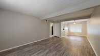 Located at 7543 S Sea Ln in San Antonio, Texas, this single-floor residence offers a well-organized layout with a cohesive, neutral design throughout. The open living area features durable wood-look flooring and a clean, neutral color palette that flows seamlessly into the kitchen. The kitchen is equipped with white cabinetry, a subway tile backsplash, light countertops, a gas range, dishwasher, and a refrigerator, complemented by a peninsula that provides additional workspace and casual dining potential. Natural light enters through blinds-fitted windows.

The bedrooms are carpeted for comfort, each outfitted with a ceiling fan and natural light from windows. The primary bedroom includes a dedicated closet with built-in shelving and cabinetry, while additional bedrooms feature generous double bi-fold closets with hanging rods and shelving. The bathrooms are finished with wood-look vinyl flooring, vanities with ample cabinet storage, and mirrors. One full bathroom includes a tub-shower combination with tile surround, while a second bathroom serves as a convenient half or three-quarter bath.

The home's consistent use of soft gray and beige tones, practical flooring choices, and functional room configurations make it a comfortable and easy-to-maintain space throughout.