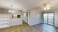 Located at 3622 Block Dr in Irving, TX, this single-floor, 2-bedroom, 1-bathroom residence offers a well-organized layout designed for functional everyday living. The open living and dining area is bright and welcoming, featuring durable wood-style flooring, a ceiling fan with light fixture, and a sliding glass door flanked by vertical blinds that provide access to the outdoors and fill the space with natural light. An additional window further enhances the airy feel of the living area.

The galley-style kitchen is efficiently designed with white cabinetry, light granite-style countertops, a stainless steel sink, and black appliances including a refrigerator, electric range, microwave, and dishwasher. A pass-through counter opens to the dining area, which also features a built-in shelving niche — a practical and distinctive architectural detail.

Both bedrooms are carpeted and finished in neutral tones, each offering natural light through windows with blinds. The primary bedroom is generously sized and includes a walk-in closet with built-in shelving. The second bedroom also benefits from its own closet. The full bathroom is clean and functional, featuring a tiled tub/shower combination and overhead cabinetry. Textured ceilings are present throughout, and the hallway connects all areas seamlessly.