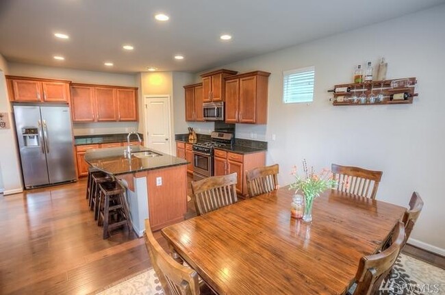 Dining room looking into kitchen. Lots of space in the kitchen, as well as pantry - 8828 Jayden Ln NE