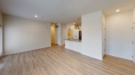 Located at 50 Cheryl Ln in Summerville, SC, this single-floor unit offers a thoughtfully designed layout with modern finishes throughout. The open-concept living area features light wood-look flooring that extends seamlessly throughout the main spaces, recessed lighting, and a peninsula kitchen that anchors the layout. The kitchen is well-equipped with crisp white shaker cabinetry, granite countertops, a subway tile backsplash, stainless steel appliances including an electric range and built-in microwave, and pendant lighting above the peninsula — a clean, functional design suited for everyday living and entertaining alike. The bedrooms are carpeted for comfort, each featuring a ceiling fan, window with blinds for natural light, and neutral wall tones that create a calm, airy atmosphere. The bathroom continues the home's cohesive aesthetic with white cabinetry, granite countertops, a framed mirror, and a tub/shower combination with tile surround. A dedicated laundry room with a full-size washer and dryer and wire shelving above adds everyday convenience. Throughout the unit, consistent use of neutral tones, modern hardware, and quality materials creates a polished, move-in-ready environment.