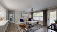 Located at 1000 Duluth Highway in Lawrenceville, GA, this 2-bedroom, 3-bathroom single-floor residence offers a thoughtfully designed layout with modern finishes throughout. The open-concept living area is a welcoming focal point, featuring wood-look flooring, crown molding, a ceiling fan, and a large window that fills the space with natural light while providing views of a private outdoor balcony. The kitchen is outfitted with white shaker cabinetry, white countertops, stainless steel appliances, a tile backsplash, and wood-look flooring, with direct access to a dedicated laundry room equipped with an in-unit washer. The primary bedroom features plush carpeting, a ceiling fan, and a generous window, complemented by an en-suite bathroom boasting a dual-sink vanity with a white countertop, ample cabinetry, and a large mirror with modern lighting. The second bedroom also features carpeting, a ceiling fan, and natural light. Additional bathrooms include a clean, bright full bath with a tub/shower combination and white vanity. Neutral gray tones throughout the home create a cohesive, contemporary ambiance that is both functional and stylish.