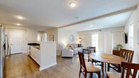 Located at 4170 Green Clover Drive in Hilliard, Ohio, this single-floor, 2-bedroom, 2-bathroom home offers a well-designed layout with comfortable living spaces and practical features throughout. The living room is bright and welcoming, featuring hardwood-style flooring, neutral walls, and a sliding glass door that fills the space with natural light and provides direct access to the outdoors. The spacious primary bedroom is appointed with plush carpeting, a ceiling fan, and multiple windows that invite natural light, complemented by a dedicated closet for ample storage. The second bedroom mirrors the same warm, neutral palette with carpeted floors and a window overlooking the exterior. Both bathrooms are finished with dark granite countertops set against white cabinetry and hardwood-style flooring, with one bathroom featuring a tub-shower combo. Each bedroom includes access to a closet, and the layout also incorporates a hallway and additional closet storage. An attached garage with an automatic opener adds everyday convenience. The home's consistent use of neutral tones, natural light, and clean finishes creates a cohesive, move-in-ready atmosphere throughout.