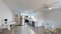 Located at 3300 Evans St in Greenville, NC, this single-story, one-bedroom, one-bathroom home offers a thoughtfully organized layout across a compact yet functional floor plan. The open-concept living and kitchen area forms the heart of the home, finished with durable wood-look flooring and neutral white walls that create a bright, clean atmosphere. A ceiling fan overhead provides year-round comfort in the living room, which receives natural light through a window with blinds.

The kitchen is well-appointed with crisp white upper cabinetry, light gray lower cabinets, and white countertops. Stainless steel appliances — including a refrigerator, electric range, over-the-range microwave, and dishwasher — provide a modern, cohesive look. The undermount sink with a brushed nickel faucet completes the space efficiently.

The generously sized primary bedroom features plush carpeting, a ceiling fan, a window with outdoor views, and a closet, offering a comfortable and private retreat. Direct access to the bathroom is conveniently located nearby.

The bathroom is clean and functional, featuring a white vanity, toilet, and a tub/shower combination with a curved curtain rod and brushed nickel fixtures. The overall design throughout the home is consistent — bright, modern, and move-in ready.