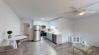 Located at 3300 Evans St in Greenville, NC, this single-story, one-bedroom, one-bathroom home offers a thoughtfully organized layout across a compact yet functional floor plan. The open-concept living and kitchen area forms the heart of the home, finished with durable wood-look flooring and neutral white walls that create a bright, clean atmosphere. A ceiling fan overhead provides year-round comfort in the living room, which receives natural light through a window with blinds.

The kitchen is well-appointed with crisp white upper cabinetry, light gray lower cabinets, and white countertops. Stainless steel appliances — including a refrigerator, electric range, over-the-range microwave, and dishwasher — provide a modern, cohesive look. The undermount sink with a brushed nickel faucet completes the space efficiently.

The generously sized primary bedroom features plush carpeting, a ceiling fan, a window with outdoor views, and a closet, offering a comfortable and private retreat. Direct access to the bathroom is conveniently located nearby.

The bathroom is clean and functional, featuring a white vanity, toilet, and a tub/shower combination with a curved curtain rod and brushed nickel fixtures. The overall design throughout the home is consistent — bright, modern, and move-in ready.